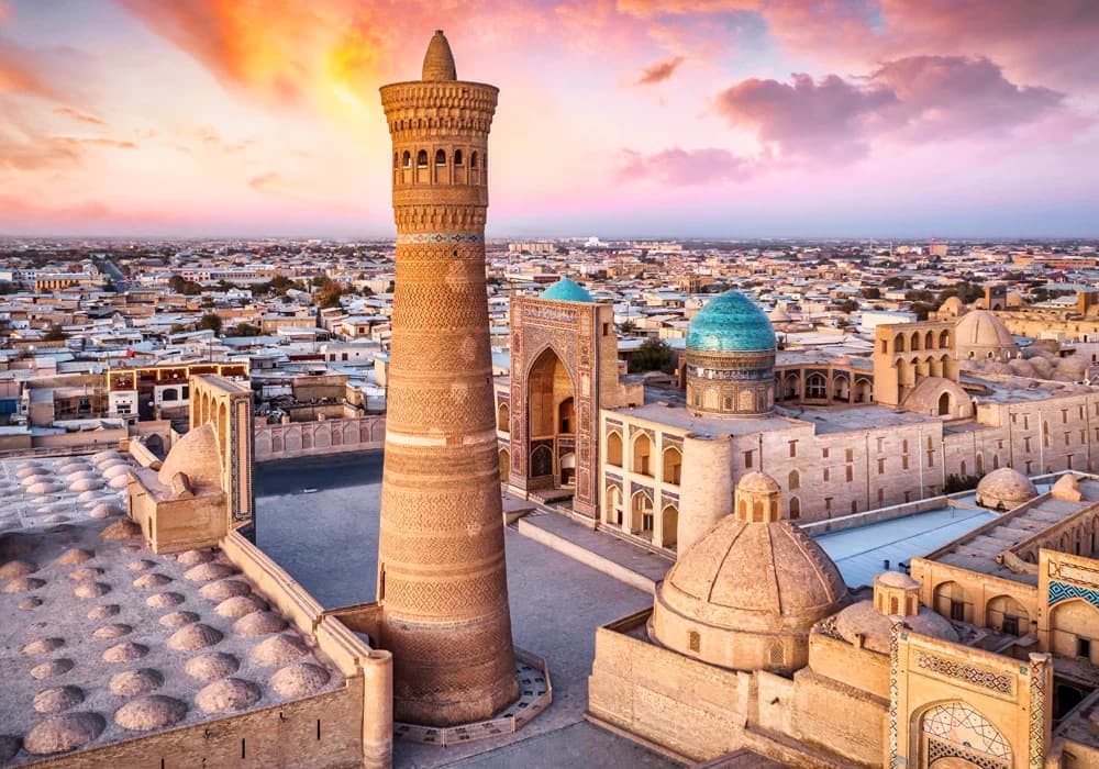 The Kalyan Minaret above the rooftops of Bukhara at sunset