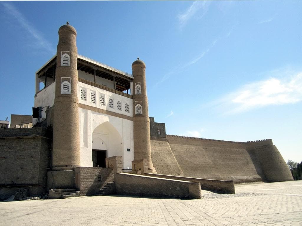 The gate seen at an angle, the wall curving away to the right