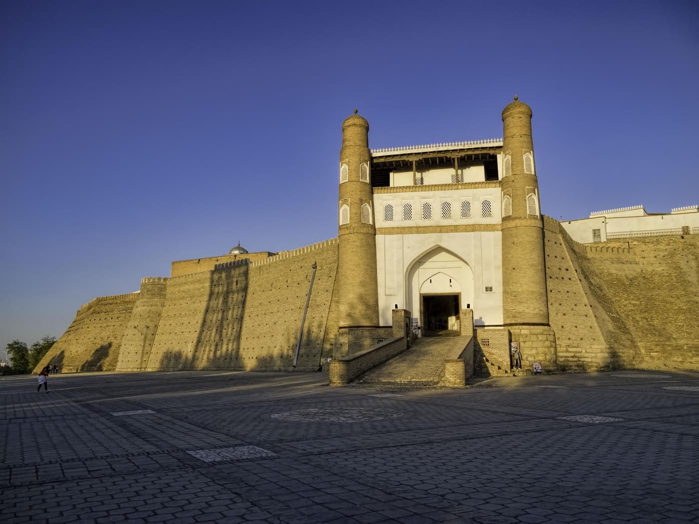 The Ark gate in evening light across the open Registan
