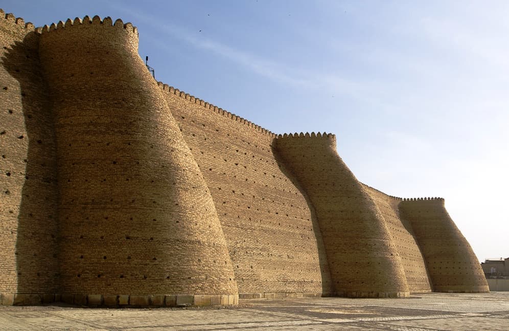 The round buttress towers of the fortress in golden light