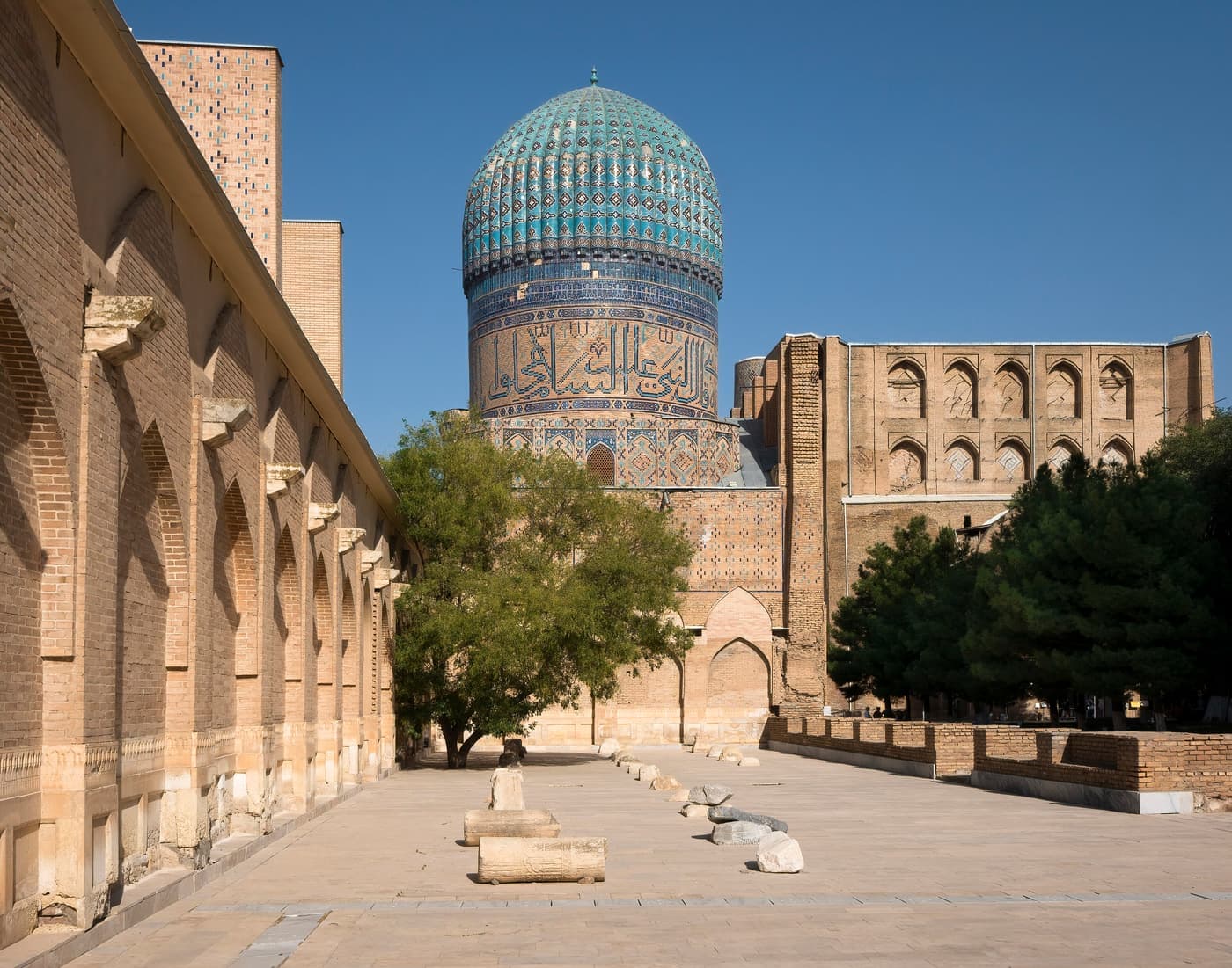 The courtyard of the Bibi-Khanym Mosque with a ribbed dome and brick arcades