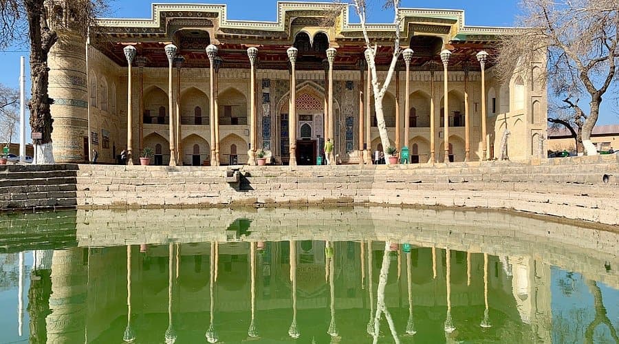 The mosque mirrored in the pond in front of it