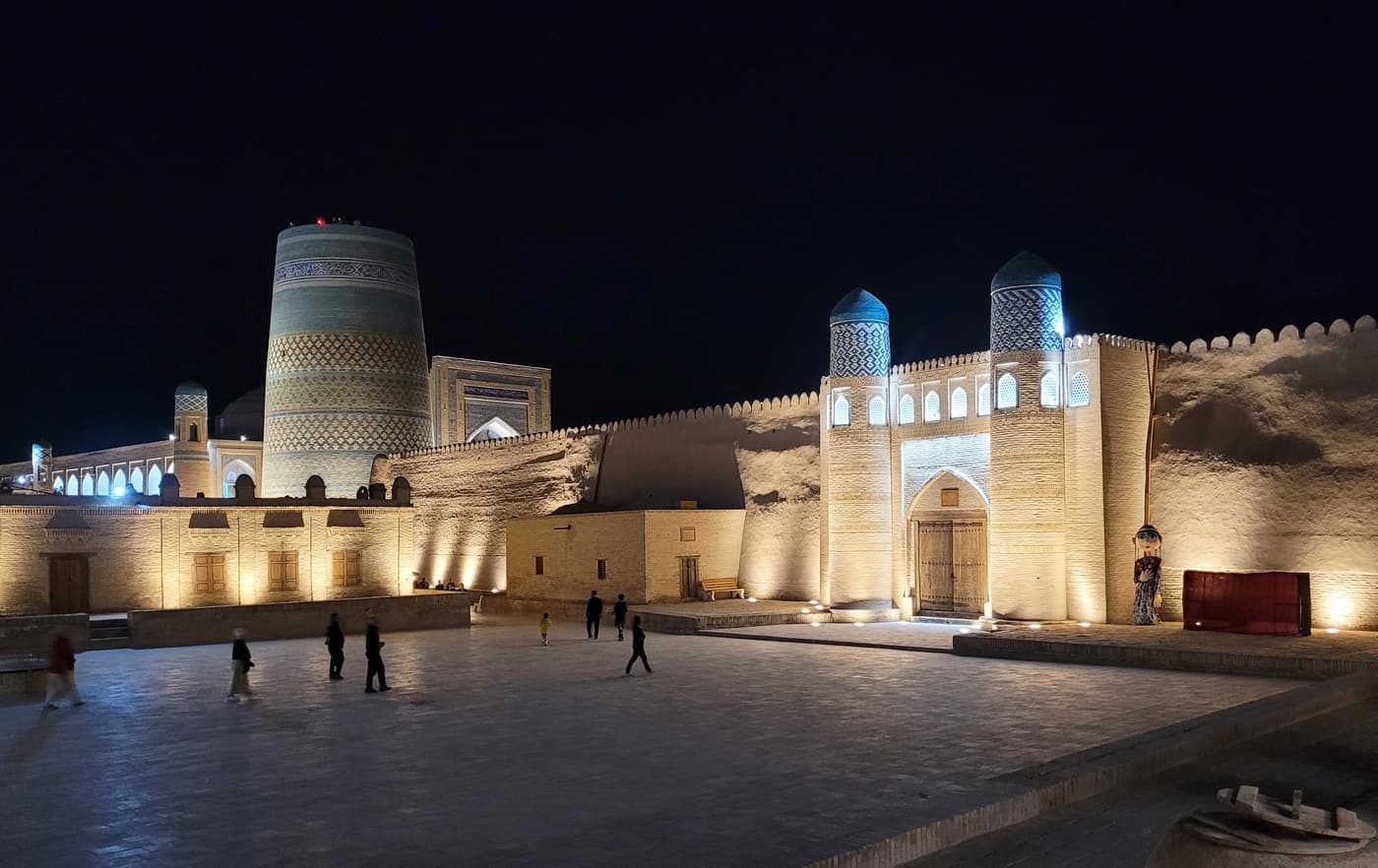 Kalta Minor and a fortress gate of Itchan Kala lit up at night