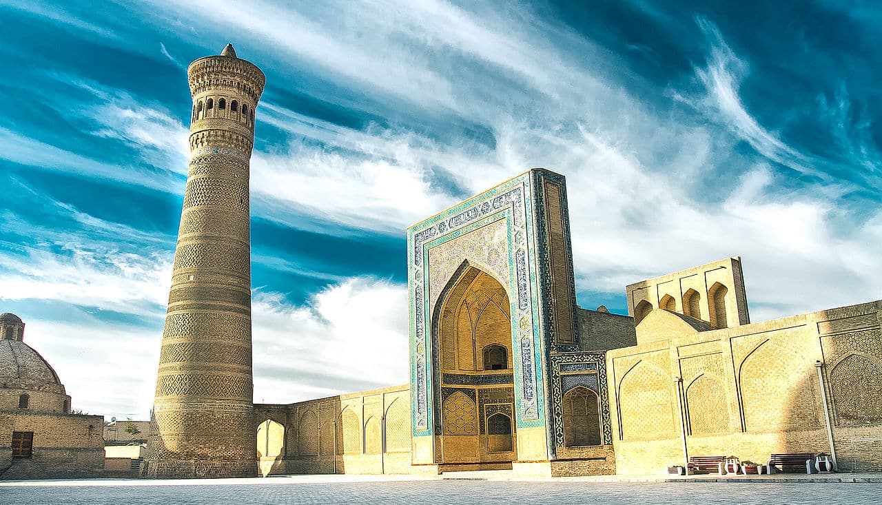 The minaret beside the portal of Mir-i-Arab under a dramatic sky
