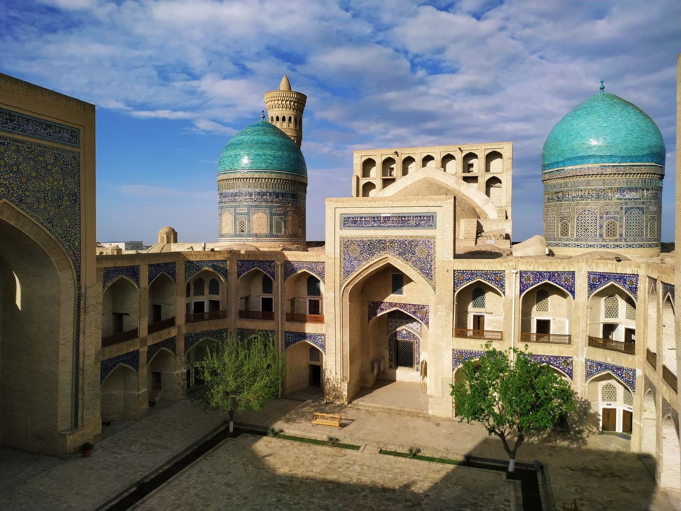 The two turquoise domes of Mir-i-Arab seen from above, with the minaret behind